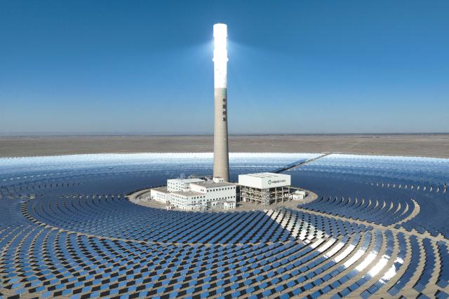 An aerial view shows the Jinta multi-energy complementary base "100-megawatt concentrated solar power (CSP) plus 600-megawatt photovoltaic" project at Baishuiquan Photovoltaic Industrial Park in Jiuquan, in northwestern China's Gansu province on October 20, 2026. (Photo by CN-STR / AFP) / China OUT