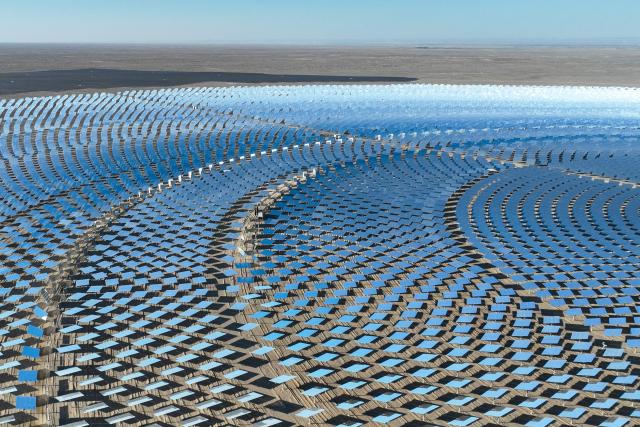 An aerial view shows the Jinta multi-energy complementary base "100-megawatt concentrated solar power (CSP) plus 600-megawatt photovoltaic" project at Baishuiquan Photovoltaic Industrial Park in Jiuquan, in northwestern China's Gansu province on October 20, 2026. (Photo by CN-STR / AFP) / China OUT