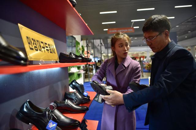 People look around the National Garment and Footwear Exhibition at the Three-Revolution Exhibition House in Pyongyang on October 21, 2026. (Photo by KIM Won Jin / AFP)