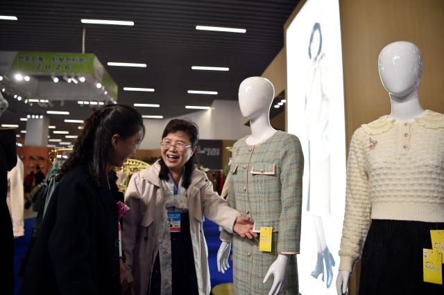 People look around the National Garment and Footwear Exhibition at the Three-Revolution Exhibition House in Pyongyang on October 21, 2026. (Photo by KIM Won Jin / AFP)