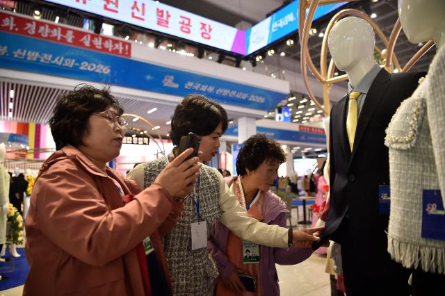 People look around the National Garment and Footwear Exhibition at the Three-Revolution Exhibition House in Pyongyang on October 21, 2026. (Photo by KIM Won Jin / AFP)