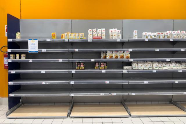 This photograph shows the empty shelves in a supermarket due to a disruption in supplies following road blockades by Italy's hauliers in Quarto, near Naples, on October 21, 2026. The protest by truck drivers, who are demonstrating against rising fuel costs, began on 16 October in the southern regions of Italy and is bringing the country to a standstill, disrupting fuel supplies to petrol stations and food supplies to supermarkets. (Photo by ELIANO IMPERATO / AFP)