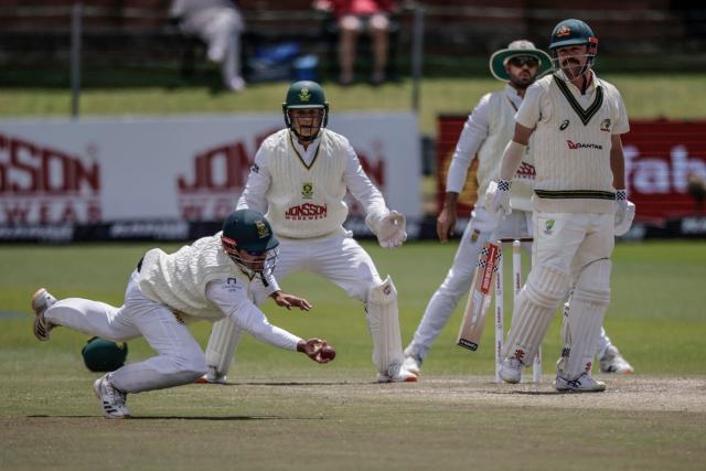 South Africa's David Bedingham (L) attempts to catch a ball played by Australia's Travis Head (R) on day five of the second Test match between South Africa and Australia at St Georges Park in Gqeberha on October 22, 2026. Australia were made to follow on after being dismissed for just 99 in reply to South Africa's first innings total of 425 for nine declared, a deficit of 326 runs, on day four at Gqeberha. (Photo by Marco Longari / AFP)