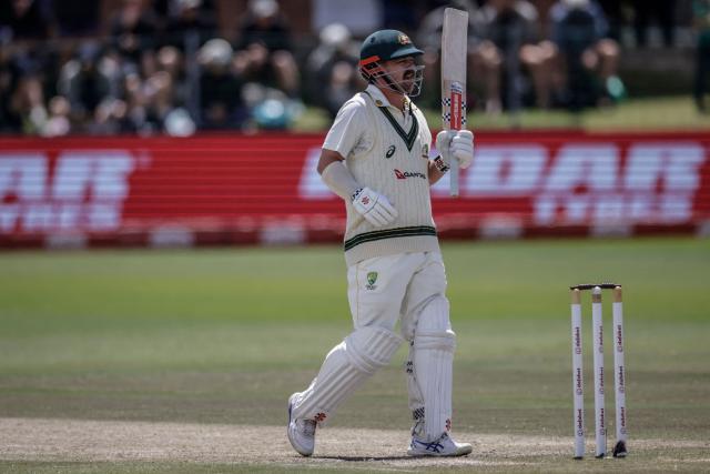Australia's Travis Head raises his bat to celebrate after scoring a century (100 runs) on day five of the second Test match between South Africa and Australia at St Georges Park in Gqeberha on October 22, 2026. Australia were made to follow on after being dismissed for just 99 in reply to South Africa's first innings total of 425 for nine declared, a deficit of 326 runs, on day four at Gqeberha. (Photo by Marco Longari / AFP)