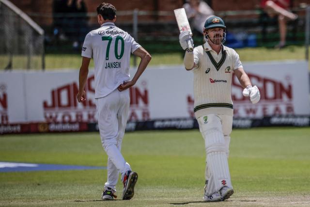 Australia's Travis Head raises his bat to celebrate after scoring a century (100 runs) on day five of the second Test match between South Africa and Australia at St Georges Park in Gqeberha on October 22, 2026. Australia were made to follow on after being dismissed for just 99 in reply to South Africa's first innings total of 425 for nine declared, a deficit of 326 runs, on day four at Gqeberha. (Photo by Marco Longari / AFP)