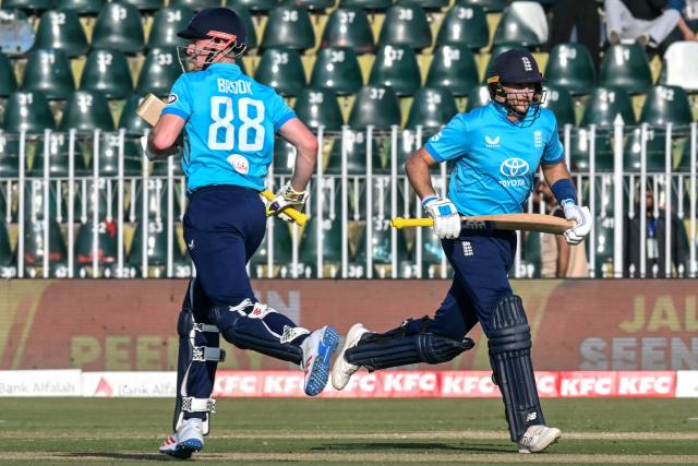 England's Joe Root (R) and his captain Harry Brook run between the wickets during the one-day international (ODI) tri-series cricket match between England and Sri Lanka at the Rawalpindi Cricket Stadium in Rawalpindi on October 22, 2026. (Photo by FAROOQ NAEEM / AFP)