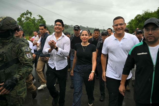 (FILES) Ecuador's presidential candidate for the Movimiento Revolución Ciudadana party (Citizen Revolution Movement), Luisa Gonzalez (C), arrives at a polling station in Canuto, Manabi province, Ecuador, on April 13, 2025. Gonzalez, who had been under investigation by authorities since January over alleged irregular funding from Venezuela for her 2023 campaign, was arrested on October 22, 2026, in Manabi, although the police confirmed her detention without specifying the reasons. (Photo by Rodrigo BUENDIA / AFP)