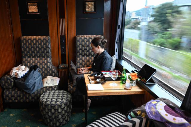 French writer Claire Berest works aboard the Twilight Express Mizukaze running from Kyoto to Matsue on October 22, 2026. Sixteen writers -- half French-speaking and half Japanese -- boarded a luxury train in Kyoto on October 22, 2026, faced with the unusual task of collectively writing a novel in under 24 hours. (Photo by Rie KIKUCHI / AFP) / To go with 'JAPAN-FRANCE-LITERATURE-TRANSPORT-TOURISM' Reportage by Julien GIRAULT