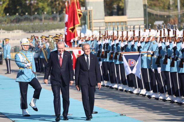 Turkish President Recep Tayyip Erdogan (L) welcomes Canadian Prime Minister Mark Carney (R) during an official ceremony at the Presidential Complex during his official visit to Turkey, in Ankara on October 22, 2026. (Photo by Adem ALTAN / AFP)