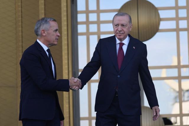 Turkish President Recep Tayyip Erdogan (R) welcomes Canadian Prime Minister Mark Carney (L) during an official ceremony at the Presidential Complex during his official visit to Turkey, in Ankara on October 22, 2026. (Photo by ADEM ALTAN / AFP)