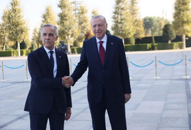 Turkish President Recep Tayyip Erdogan (R) welcomes Canadian Prime Minister Mark Carney (L) during an official ceremony at the Presidential Complex during his official visit to Turkey, in Ankara on October 22, 2026. (Photo by ADEM ALTAN / AFP)