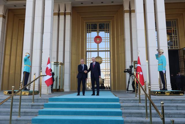 Turkish President Recep Tayyip Erdogan (R) welcomes Canadian Prime Minister Mark Carney (L) during an official ceremony at the Presidential Complex during his official visit to Turkey, in Ankara on October 22, 2026. (Photo by ADEM ALTAN / AFP)