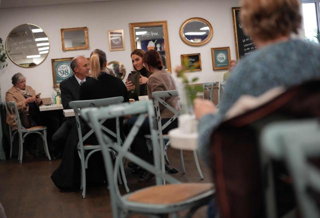 Britain's Catherine, Princess of Wales, talks with East Anglia's Children's Hospices' (EACH) Director of Retail Ian Nicolson, and café manager Morgan-Rose Neary, during a visit to Café 98 inside EACH's shop in Hoveton, eastern England on October 22, 2026. Cafe 98, run by East Anglia's Children's Hospices (EACH), is the charity's first and only cafe, forming part of EACH's fundraising operation and serving as a community hub for local residents. (Photo by Ben Stansall / POOL / AFP)