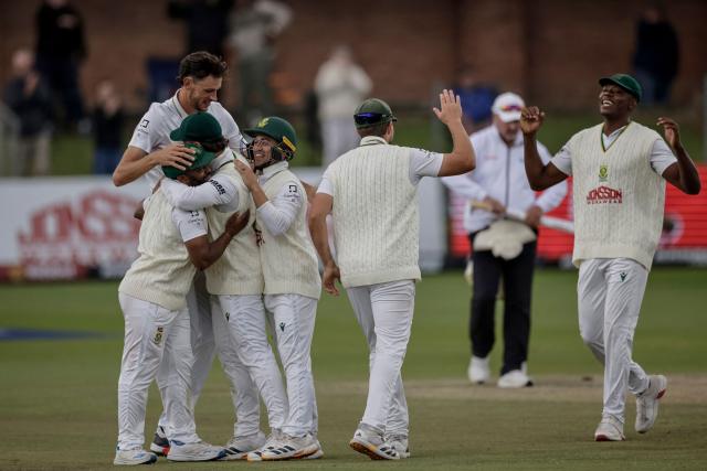 TOPSHOT - South Africa's players celebrate the dismissal of Australia's Josh Hazlewood and winning the second Test match between South Africa and Australia at St Georges Park in Gqeberha on October 22, 2026. Australia were made to follow on after being dismissed for just 99 in reply to South Africa's first innings total of 425 for nine declared, a deficit of 326 runs, on day four at Gqeberha. (Photo by Marco Longari / AFP)