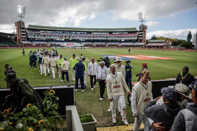 South Africa's and Australia's players greet each other at the end of day five of the second Test match between South Africa and Australia at St Georges Park in Gqeberha on October 22, 2026. Australia were made to follow on after being dismissed for just 99 in reply to South Africa's first innings total of 425 for nine declared, a deficit of 326 runs, on day four at Gqeberha. (Photo by Marco Longari / AFP)