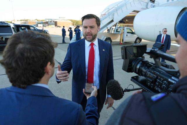 US Vice President JD Vance speaks to reporters before boarding Air Force Two at Cincinnati/Northern Kentucky International Airport in Hebron, Kentucky, on October 22, 2026. Vance is travelling to Nebraska for a midterm campaign rally. (Photo by Jacquelyn Martin / POOL / AFP)