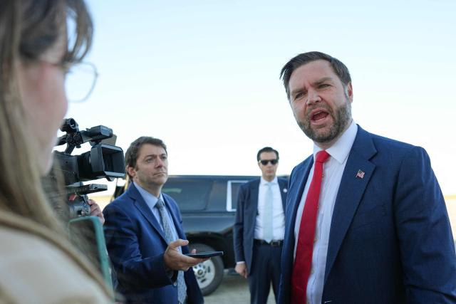 US Vice President JD Vance speaks to reporters before boarding Air Force Two at Cincinnati/Northern Kentucky International Airport in Hebron, Kentucky, on October 22, 2026. Vance is travelling to Nebraska for a midterm campaign rally. (Photo by Jacquelyn Martin / POOL / AFP)