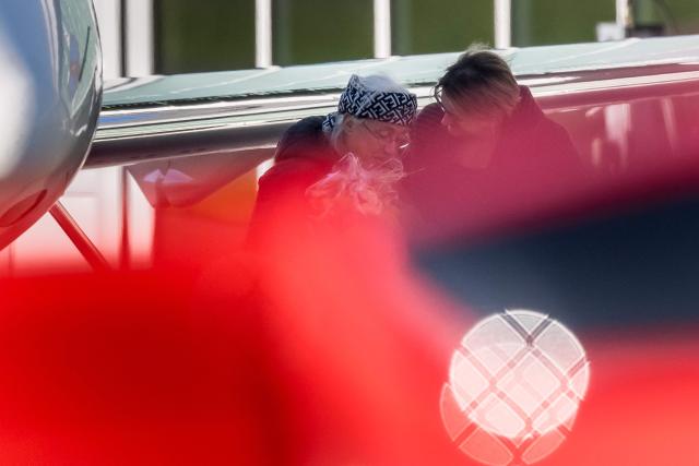 This photograph shows former Swiss hostage Claudia Abbt (L) greeted with flowers upon her arrival at Belp Airport near Bern, on October 22, 2026. A Swiss and an Austrian woman kidnapped by suspected jihadists in Niger more than a year and a half ago have been freed with Libya's intervention, Bern and Vienna announced October 22, 2026. Swiss national Claudia Abbt, 69, arrived in Libya's eastern city of Benghazi together with 76-year-old Eva Gretzmacher. (Photo by Fabrice COFFRINI / AFP)