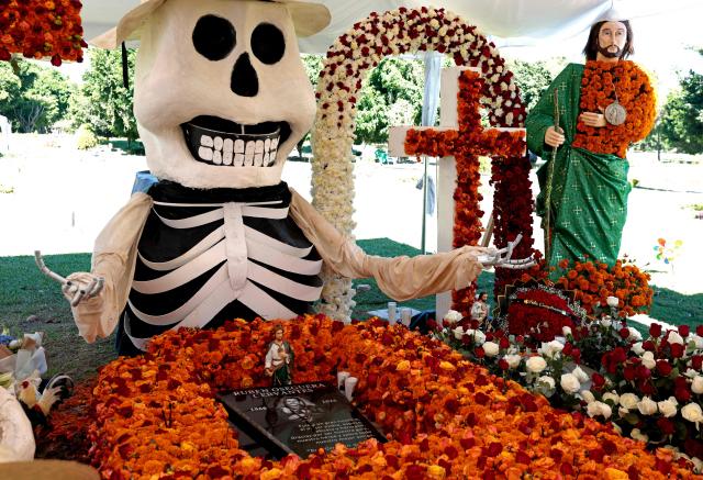This image shows a detail of an offering on the grave of Nemesio Oseguera Cervantes, aka "El Mencho" --founder and leader of the Jalisco New Generation Cartel (CJNG)-- within the framework of the upcoming Day of the Dead celebrations, at the Recinto la Paz private cemetery in Zapopan, state of Jalisco, on October 22, 2026. Oseguera Cervantes was captured and killed during a confrontation with federal forces last April 22. (Photo by ULISES RUIZ / AFP)