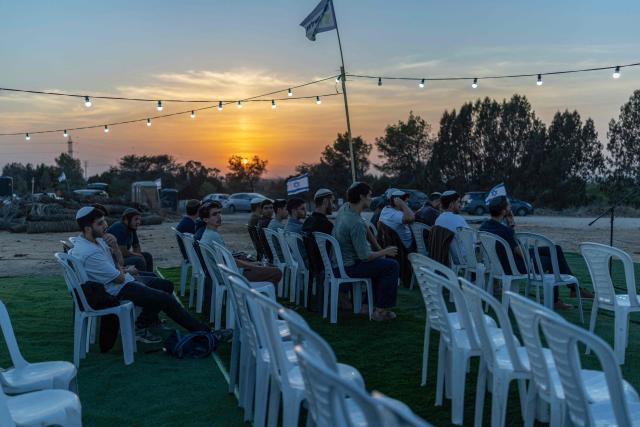 Israeli right-wing members of the Nachala settler organisation attend a Torah lecture at a newly built camp site at a field near the Israeli Kibbutz of Nahal Oz in southern Israel, by the Israel-Gaza border on October 22, 2026. (Photo by Ilia YEFIMOVICH / AFP)