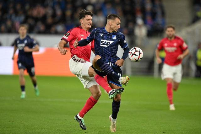 Hoffenheim's German midfielder #19 Tim Lemperle and Lyon's Austrian defender #20 Felix Bacher vie for the ball during the UEFA Europa League  football match between Hoffenheim and Olympique Lyonnais in Sinsheim, southern Germany, on October 22, 2026. (Photo by THOMAS KIENZLE / AFP)