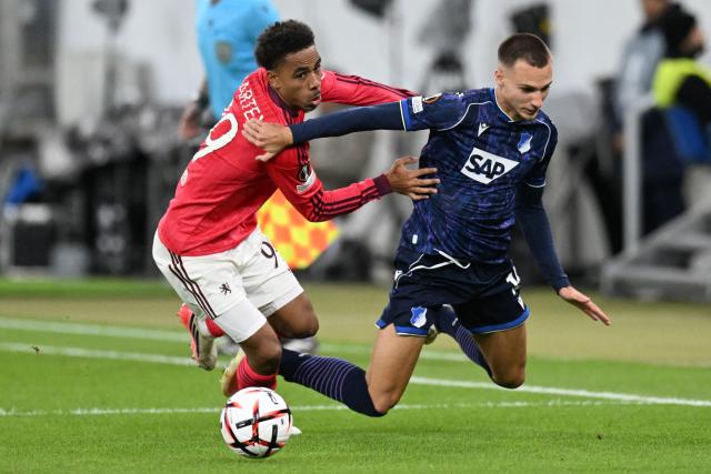 Lyon's Danish midfielder #99 Noah Nartey and Hoffenheim's German midfielder #19 Tim Lemperle vie for the ball during the UEFA Europa League  football match between Hoffenheim and Olympique Lyonnais in Sinsheim, southern Germany, on October 22, 2026. (Photo by THOMAS KIENZLE / AFP)