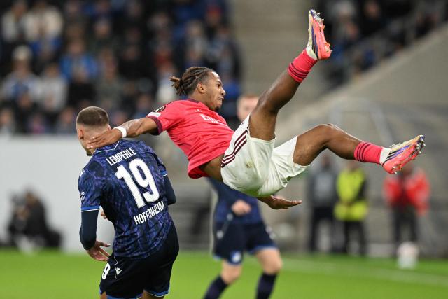 Hoffenheim's German midfielder #19 Tim Lemperle fouls Lyon's French defender #37 Steeve Kango during the UEFA Europa League  football match between Hoffenheim and Olympique Lyonnais in Sinsheim, southern Germany, on October 22, 2026. (Photo by THOMAS KIENZLE / AFP)
