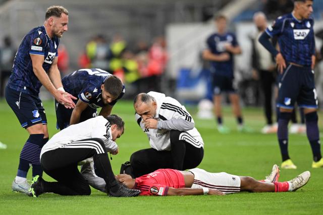 Lyon's French defender #37 Steeve Kango receives medical attention during the UEFA Europa League  football match between Hoffenheim and Olympique Lyonnais in Sinsheim, southern Germany, on October 22, 2026. (Photo by THOMAS KIENZLE / AFP)