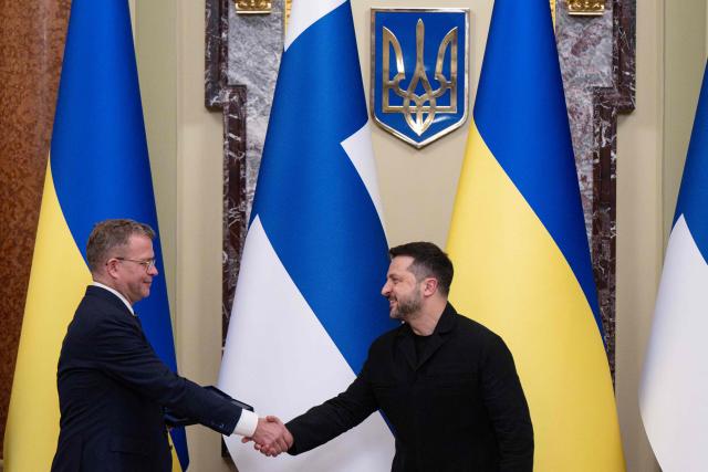 Ukraine's President Volodymyr Zelensky (R) shakes hands with Finland's Prime Minister as he awards him the Order of Prince Yaroslav the Wise, 2nd class, during their meeting in Kyiv on October 22, 2026, amid the Russian invasion of Ukraine. (Photo by Genya SAVILOV / AFP)