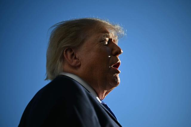 US President Donald Trump talks to the media before boarding Marine One on the South Lawn of the White House in Washington, DC, on October 22, 2026. President Trump is travelling to Iowa to speak at a midterm campaign rally. (Photo by Alex WROBLEWSKI / AFP)