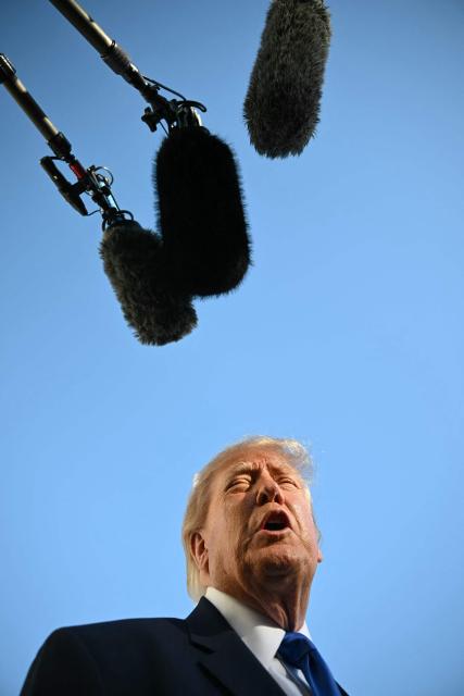 US President Donald Trump talks to the media before boarding Marine One on the South Lawn of the White House in Washington, DC, on October 22, 2026. President Trump is travelling to Iowa to speak at a midterm campaign rally. (Photo by Alex WROBLEWSKI / AFP)