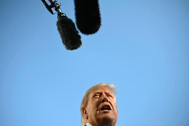 US President Donald Trump talks to the media before boarding Marine One on the South Lawn of the White House in Washington, DC, on October 22, 2026. President Trump is travelling to Iowa to speak at a midterm campaign rally. (Photo by Alex WROBLEWSKI / AFP)