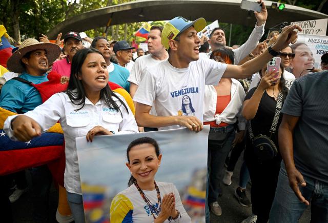 Supporters of Venezuelan opposition leader and Nobel Peace Prize winner Maria Corina Machado shout slogans during a rally to demand elections in Caracas on October 22, 2026. (Photo by Federico PARRA / AFP)
