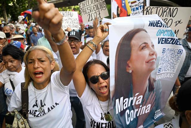 Supporters of Venezuelan opposition leader and Nobel Peace Prize winner Maria Corina Machado shout slogans during a rally to demand elections in Caracas on October 22, 2026. (Photo by Federico PARRA / AFP)