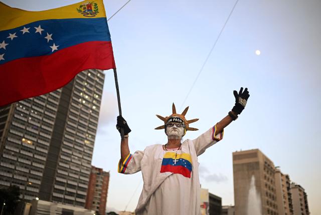 A supporter of Venezuelan opposition leader and Nobel Peace Prize winner Maria Corina Machado waves a Venezuelan flag during a rally to demand elections in Caracas on October 22, 2026. (Photo by Federico PARRA / AFP)