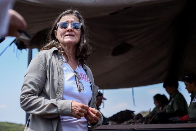 Forensic archaeologist Silvana Turner stands next to forensic personnel from the Argentine Forensic Anthropology Team (EAAF) searching for the human remains of people who disappeared during the last military dictatorship (1976–1983), at La Loma del Torito, on the La Calera military base on the outskirts of Cordoba, Argentina, on October 22, 2026, near the former clandestine detention, torture and extermination center known as "La Perla.".  (Photo by Cesar Heredia / AFP)