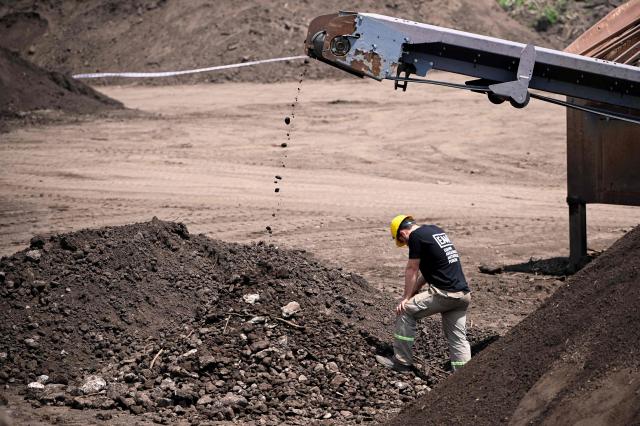 A forensic expert from the Argentine Forensic Anthropology Team (EAAF) searches for the human remains of people who disappeared during the last military dictatorship (1976–1983), at La Loma del Torito, on the La Calera military base on the outskirts of Cordoba, Argentina, on October 22, 2026, near the former clandestine detention, torture and extermination center known as "La Perla.".  (Photo by CESAR HEREDIA / AFP)