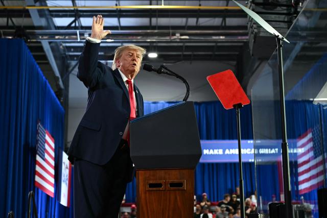 US President Donald Trump speaks at a midterm election campaign rally at Sioux Gateway Airport in Sioux City, Iowa on October 22, 2026. President Trump is travelling the country to try to give a boost to Republicans in tight midterm races. (Photo by Kent NISHIMURA / AFP)