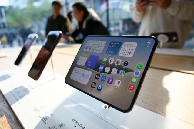 The iPhone Duo is displayed at an Apple store in Beijing on October 23, 2026. (Photo by WANG Zhao / AFP)