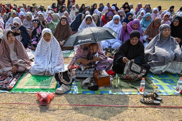 Indonesian Muslims participate in the Istisqa rain prayer to pray for rain amidst a prolonged El Nino-induced drought at a field in Surabaya, East Java province on October 23, 2026. (Photo by JUNI KRISWANTO / AFP)
