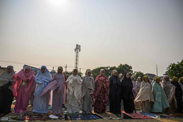 Indonesian Muslims participate in the Istisqa rain prayer to pray for rain amidst a prolonged El Nino-induced drought at a field in Surabaya, East Java province on October 23, 2026. (Photo by JUNI KRISWANTO / AFP)
