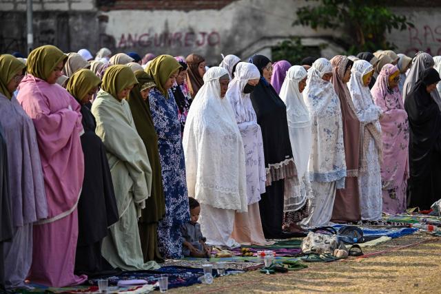 Indonesian Muslims participate in the Istisqa rain prayer to pray for rain amidst a prolonged El Nino-induced drought at a field in Surabaya, East Java province on October 23, 2026. (Photo by JUNI KRISWANTO / AFP)