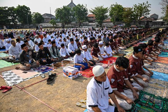 Muslim students and residents participate in the Istisqa rain prayer gathering to pray for rain amidst a prolonged El Nino-induced drought at a field in Surabaya, East Java province on October 23, 2026. (Photo by JUNI KRISWANTO / AFP)