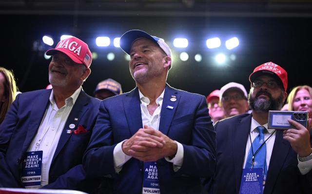 Supporters listen to US President Donald Trump speak at a midterm election campaign rally at Sioux Gateway Airport in Sioux City, Iowa on October 22, 2026. President Trump is travelling the country to try to give a boost to Republicans in tight midterm races. (Photo by Kent NISHIMURA / AFP)