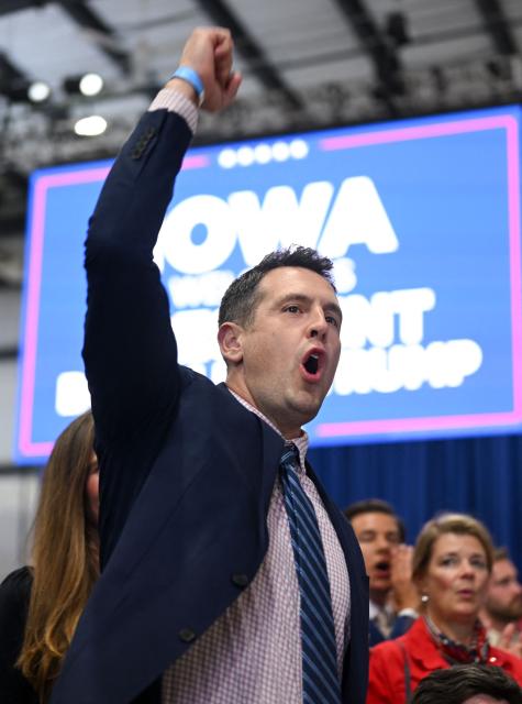 Republican gubernatorial candidate Zach Lahn cheers as US President Donald Trump speaks at a midterm election campaign rally at Sioux Gateway Airport in Sioux City, Iowa on October 22, 2026. President Trump is travelling the country to try to give a boost to Republicans in tight midterm races. (Photo by Kent NISHIMURA / AFP)