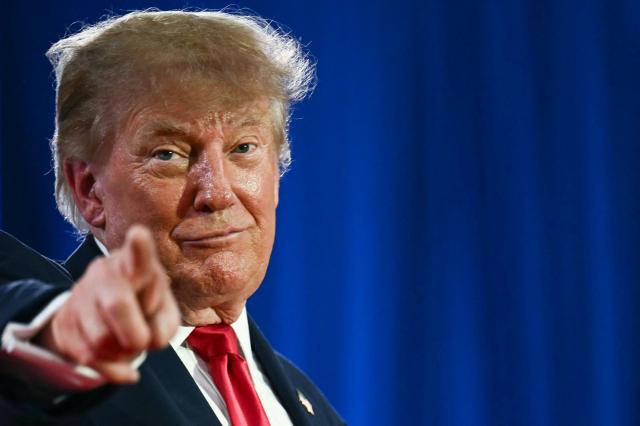 US President Donald Trump points during a midterm election campaign rally at Sioux Gateway Airport in Sioux City, Iowa on October 22, 2026. President Trump is travelling the country to try to give a boost to Republicans in tight midterm races. (Photo by Kent NISHIMURA / AFP)