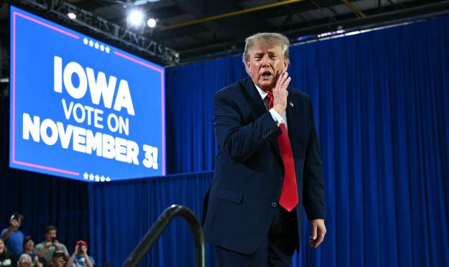 US President Donald Trump gestures during a midterm election campaign rally at Sioux Gateway Airport in Sioux City, Iowa on October 22, 2026. President Trump is travelling the country to try to give a boost to Republicans in tight midterm races. (Photo by Kent NISHIMURA / AFP)