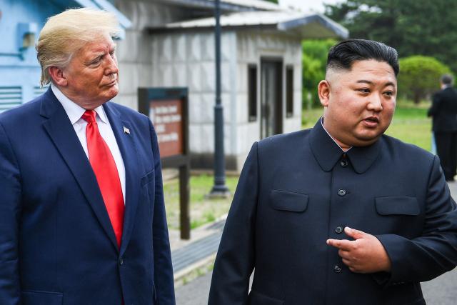 (FILES) North Korea's leader Kim Jong Un speaks as he stands with US President Donald Trump south of the Military Demarcation Line that divides North and South Korea, in the Joint Security Area (JSA) of Panmunjom in the Demilitarized zone (DMZ) on June 30, 2019. As world leaders prepare to gather in Shenzhen for November's APEC summit, speculation is mounting over a possible meeting between US President Donald Trump and North Korean leader Kim Jong Un -- a prospect experts say remains remote. (Photo by Brendan Smialowski / AFP)