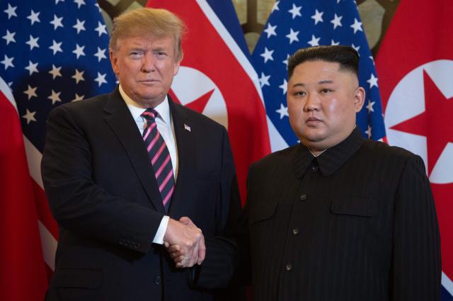 (FILES) US President Donald Trump (L) shakes hands with North Korea's leader Kim Jong Un before a meeting at the Sofitel Legend Metropole hotel in Hanoi on February 27, 2019. As world leaders prepare to gather in Shenzhen for November's APEC summit, speculation is mounting over a possible meeting between US President Donald Trump and North Korean leader Kim Jong Un -- a prospect experts say remains remote. (Photo by Saul LOEB / AFP)