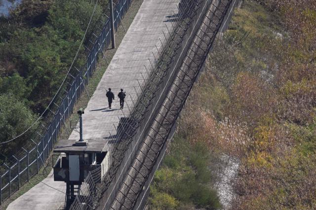 (FILES) South Korean soldiers patrol along a military fence on the south side of the Demilitarised Zone (DMZ) dividing the two Koreas, as seen from a South Korean observatory in the border city of Paju on October 20, 2026. South Korea proposed on October 23, 2026 military talks with North Korea to "mutually confirm the precise location" of their border and discuss restoring communication channels, after an explosion in the DMZ further strained relations. (Photo by Jung Yeon-je / AFP)